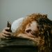 stressed woman scrolling through her phone